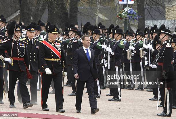 Russian President Dmitry Medvedev and Norwegian King Harald walk past an honor guard near the Norwegian Royal Palace in Oslo on April 26, 2010....