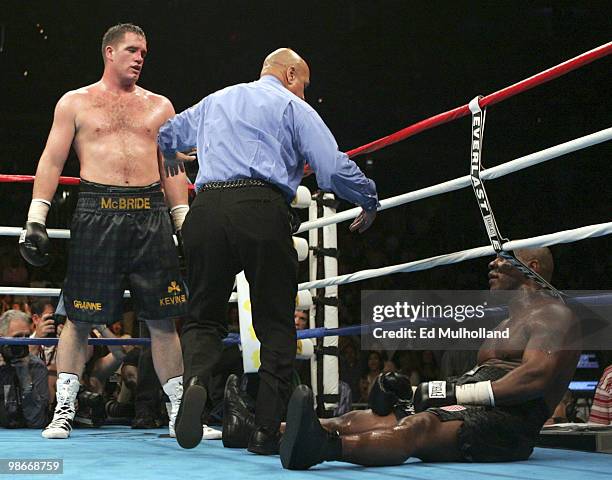 Kevin McBride looks down at a fallen Mike Tyson during the 6th round of their fight at the MCI Center in Washington, DC. McBride won the fight when...