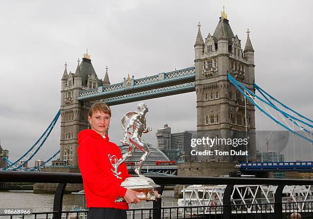 Winner of Women's race Liliya Shobukhova poses with the trophy during the 2010 Virgin London Marathon winners photocal at The Tower Hotel on April...