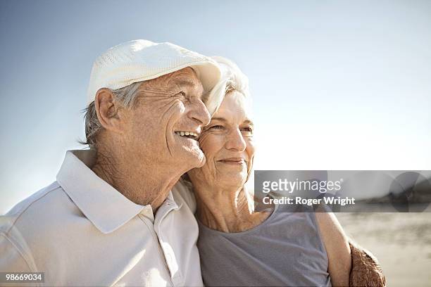 senior couple on beach - coppia anziana foto e immagini stock