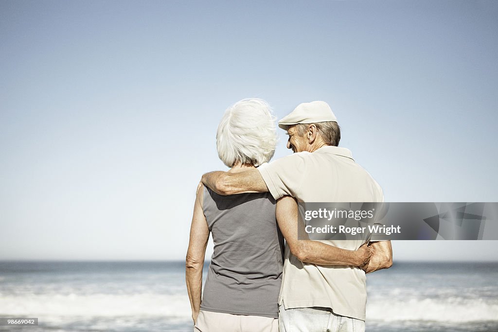Senior couple from behind on beach