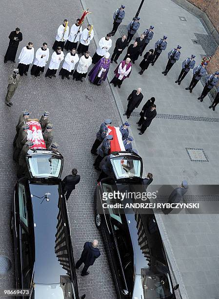 Soldiers load the coffins of Poland's president Lech Kaczynski and his wife Maria into hearses outside St.John's Cathedral in Warsaw on April 18,...