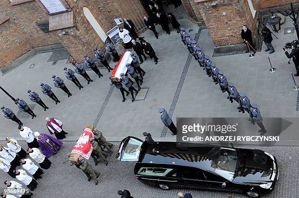 Soldiers carry the coffins of Poland's president Lech Kaczynski and his wife Maria out of St.John's Cathedral in Warsaw on April 18, 2010 as the...