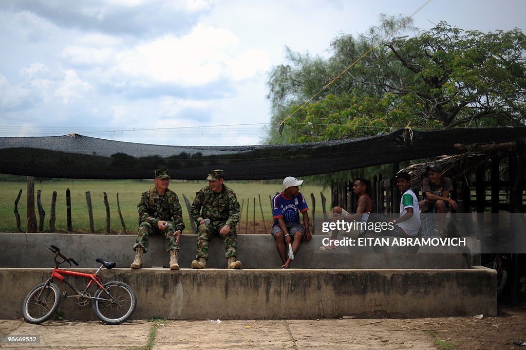 Soldiers and villagers gather at a farm