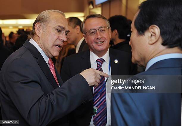 Secretary General Angel Gurría chats with South Korean Finance Minister Yoon Jeung-hyun as Australia's Treasurer Wayne Swan looks on as they arrive...