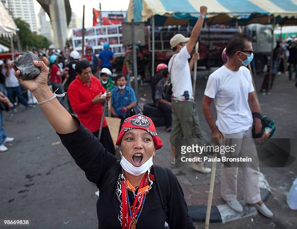 Thai protesters hold a rock as tensions rise inside the red shirt camp and the protesters take up arms April 26, 2010 in Bangkok Thailand. Thailand's...