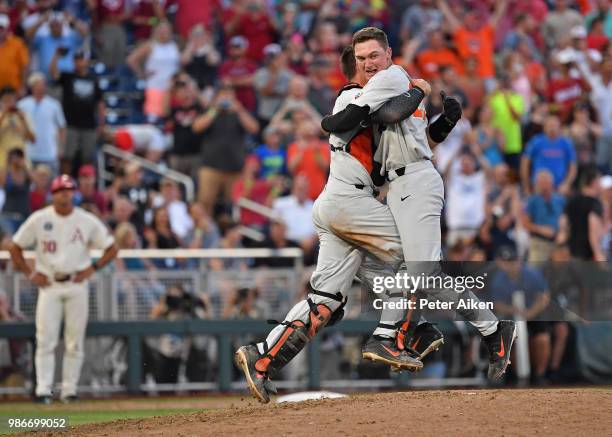 Pitcher Kevin Abel of the Oregon State Beavers and Catcher Adley Rutschman embrace to celebrate after defeating the Arkansas Razorbacks for the...