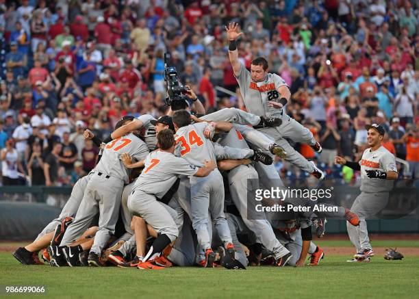 Oregon State Beavers players leap into a dog pile celebrating after defeating the Arkansas Razorbacks for the National Championship during the...