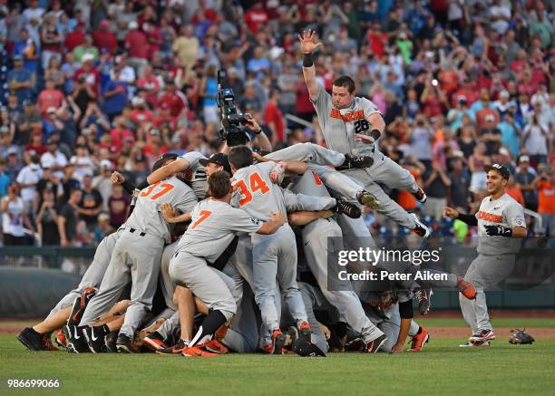 Oregon State Beavers players leap into a dog pile celebrating after defeating the Arkansas Razorbacks for the National Championship during the...