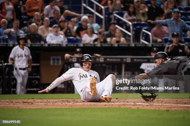 Derek Dietrich of the Miami Marlins scores a run during the game against the Arizona Diamondbacks at Marlins Park on June 25, 2018 in Miami, Florida.