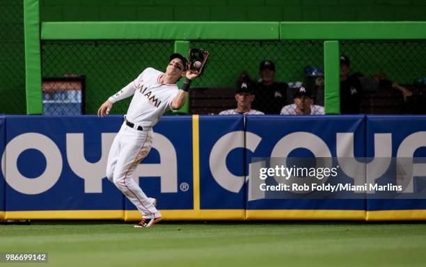 Derek Dietrich of the Miami Marlins makes a catch in the outfield during the game against the Arizona Diamondbacks at Marlins Park on June 25, 2018...