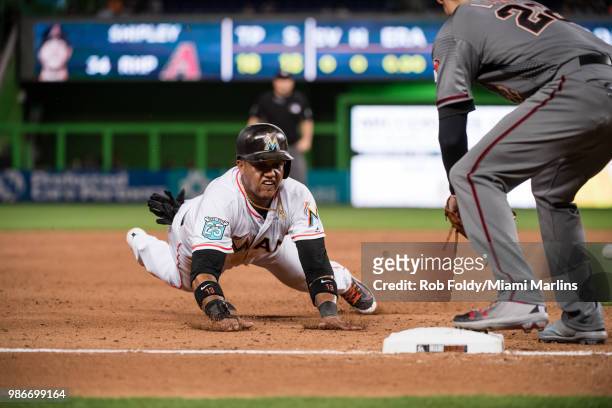 Starlin Castro of the Miami Marlins slides safely into third base during the game against the Arizona Diamondbacks at Marlins Park on June 25, 2018...