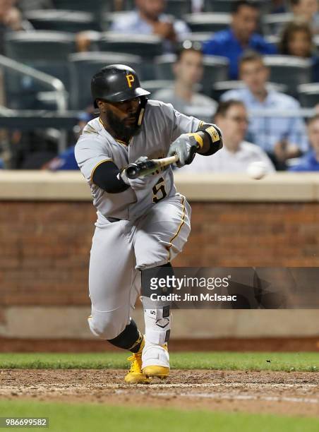 Josh Harrison of the Pittsburgh Pirates eighth inning bunt single against the New York Mets at Citi Field on June 26, 2018 in the Flushing...