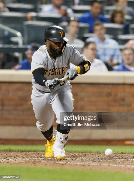 Josh Harrison of the Pittsburgh Pirates eighth inning bunt single against the New York Mets at Citi Field on June 26, 2018 in the Flushing...