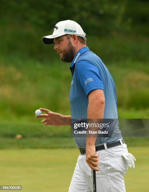 Marc Leishman of Australia acknowledges the gallery on the sixth hole during the first round of the Quicken Loans National at TPC Potomac at Avenel...