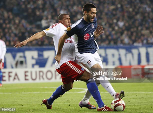 Jerome Boateng of Hamburg battles for the ball with Clint Dempsey of Fulham during the UEFA Europa League semi final first leg match between...