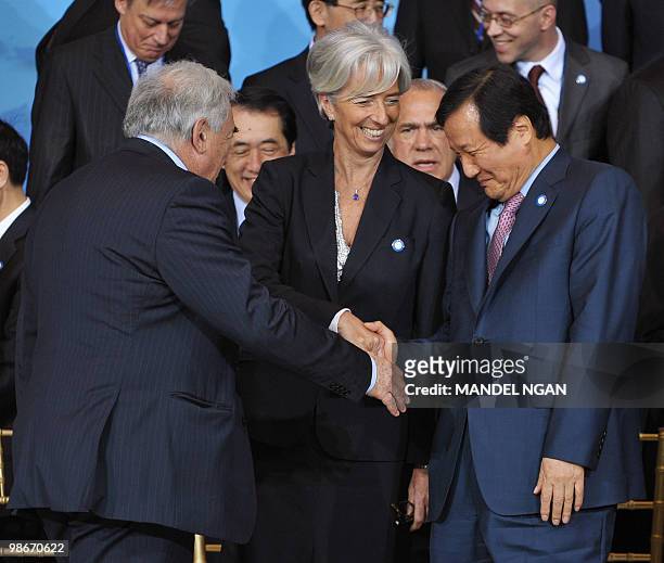 Managing Director Dominique Strauss-Kahn and France's Finance Minister Christine Lagarde shake hands with South Korean Finance Minister Yoon...