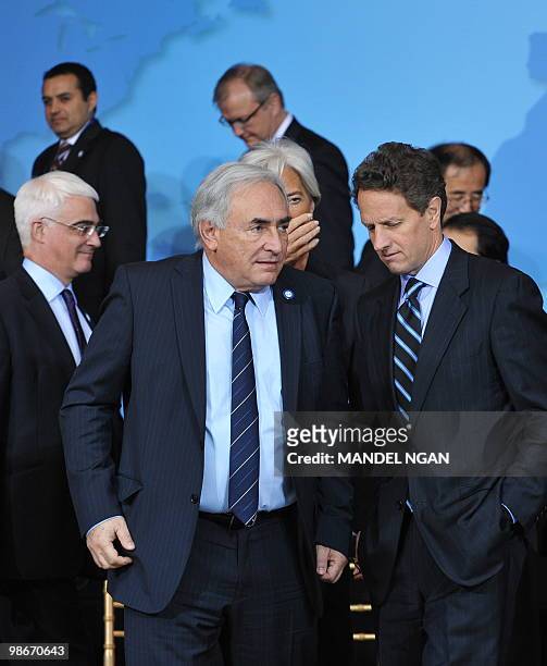 Managing Director Dominique Strauss-Kahn chats with US Treasury Secretary Tim Geithner after posing for the G-20 Finance Ministers and Central Bank...