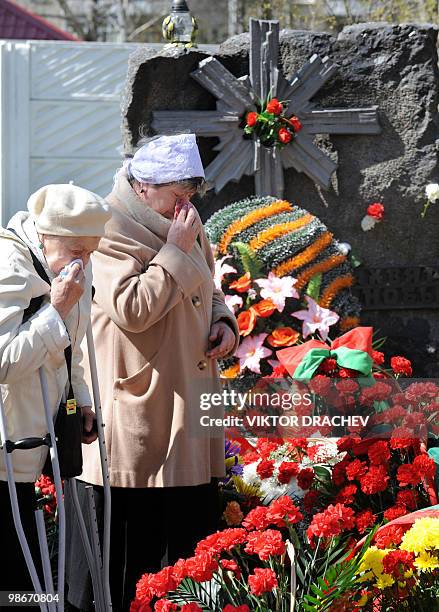 Eldery Belarus women cry near the monument to victims of the Chernobyl nuclear reactor accident during a memorial ceremony in Minsk on April 26, 2010...