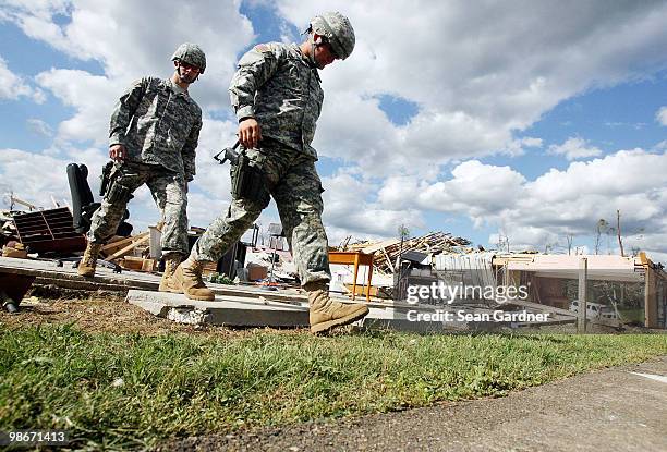 Nation Gauardsmen Jacob Trest of Bay Springs, MS and Joseph Warren of Forest, MS walk over debris in front of what was the Hillcrest Baptist Church...