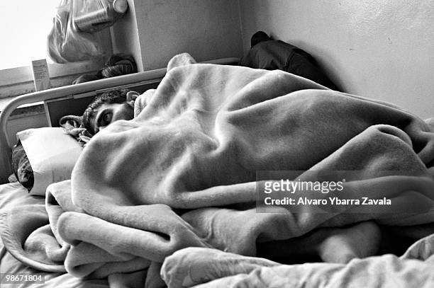 Abdulazim shivers under a blanket while suffering from heroin withdrawal symptoms in Kabul's drug rehabilitation centre. He became addicted to heroin...