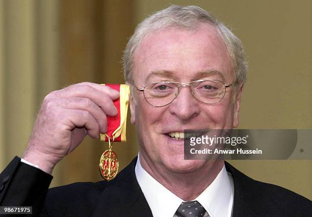 Michael Caine poses after he received his Knighthood from the Queen at Buckingham Palace on November 16, 2000 in London, Engand.