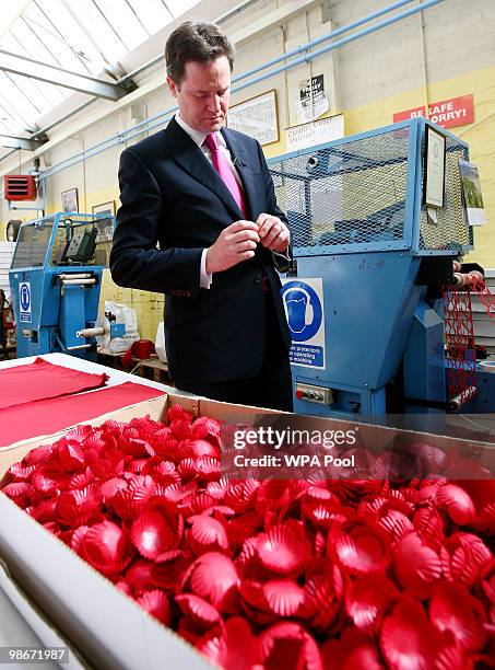 Liberal Democrat leader Nick Clegg inspects a poppy during an election campaign visit to the Lady Haig Poppy Factory on April 26, 2010 in Edinburgh,...