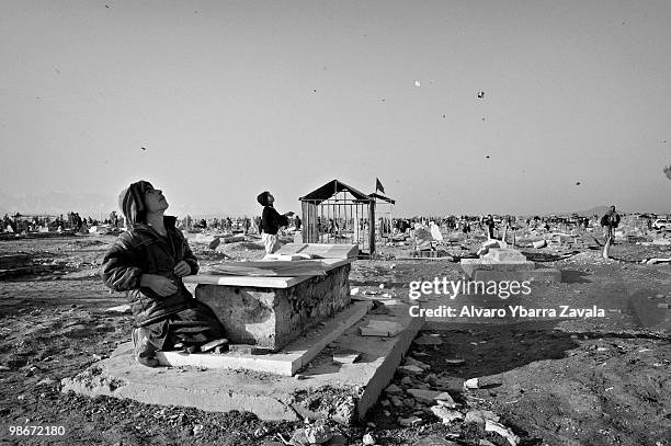 Children play with kites in a graveyard in Kabul. Afghanistan has become the key war zone for the new US administration. After years of focus on...