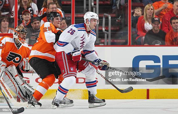 Matt Carle and Brian Boucher of the Philadelphia Flyers battle in front of the net against Erik Christensen of the New York Rangers on April 11, 2010...