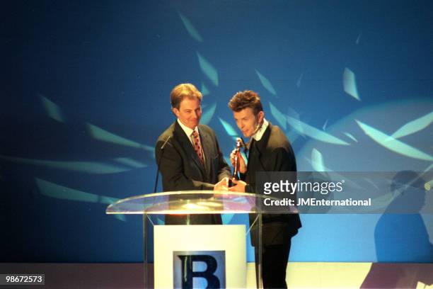 Labour Leader of the Opposition Tony Blair presenting an outstanding contribution award to David Bowie at the Brit Awards at Earls Court on February...