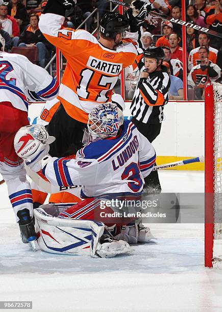 Jeff Carter of the Philadelphia Flyers battles in the crease against Henrik Lundqvist of the New York Rangers with referee Kerry Fraser calling the...