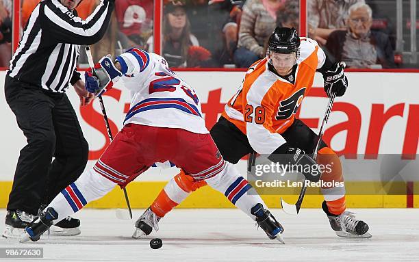 Claude Giroux of the Philadelphia Flyers battles for the puck on a face-off against Chris Drury of the New York Rangers on April 11, 2010 at the...