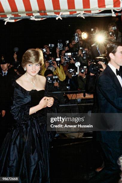 Lady Diana Spencer, wearing a strapless black taffeta dress designed by David and Elizabeth Emanuel, attends a fundraising concert and reception at...