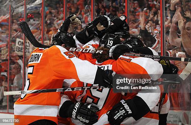 Matt Carle of the Philadelphia Flyers is mobbed by his teammates after scoring the game tying goal in the third period against the New York Rangers...