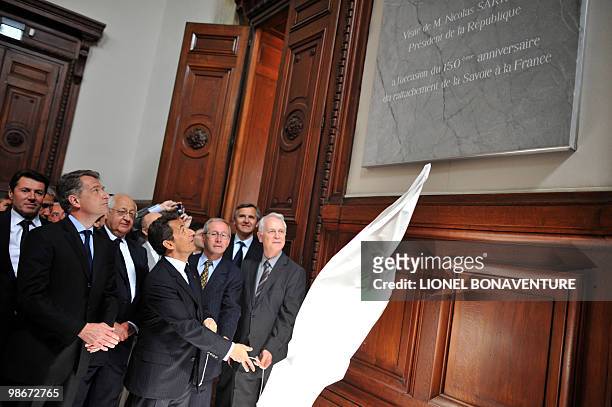 French President Nicolas Sarkozy unveils a plaque at the Chambery's justice court on April 22, 2010 in the French Alps, during a ceremony marking the...