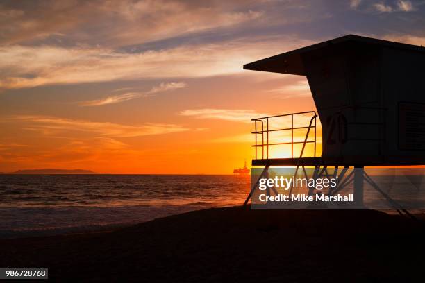 sunset silhouettes - lifeguard hut stock pictures, royalty-free photos & images