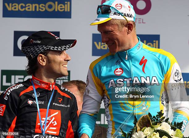 Alejandro Valverde of Spain and Caisse D'Epargne shares a joke with race winner Alexandre Vinokourov of Kazakhstan and Astana as they stand on the...