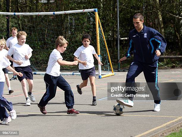 Birmingham City football player Mitch McPike has a kick around during an AEGON schools visit to Moseley C of E Primary school on April 26, 2010 in...