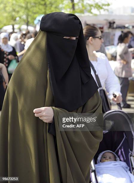 Samira wearing a niqab, the islamic full veil, walks in a market of Venissieux near Lyon, eastern France, on April 22, 2010. French government will...