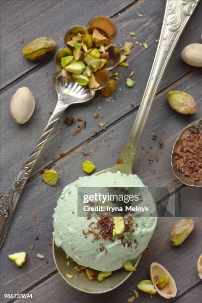scoop of homemade pistachio ice cream with chopped - pistachio ice cream stock pictures, royalty-free photos & images