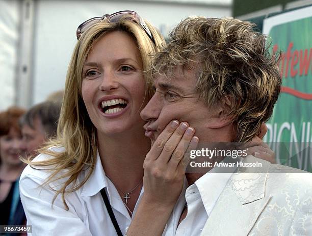 Rod Stewart and his girlfriend Penny Lancaster picnic on July 6, 2002 in Hyde Park, London, England.