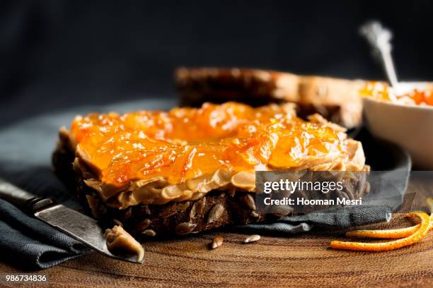 peanut butter and orange marmalade on toast. - marmalade stockfoto's en -beelden