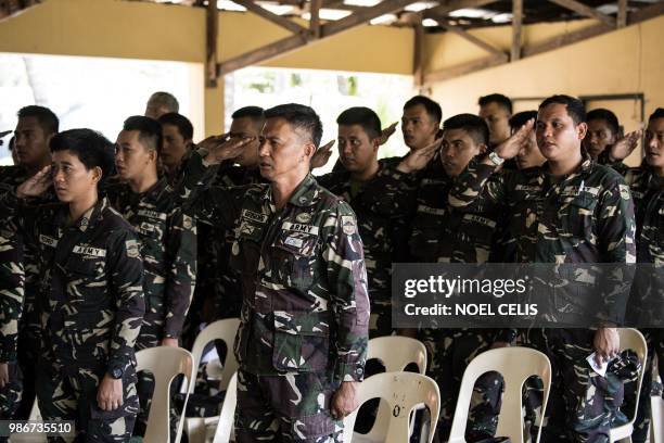 This photo taken on May 11, 2018 shows Philippine soldiers singing the national anthem befiore a fake news lecture in Philippine Army Camp Jaime...