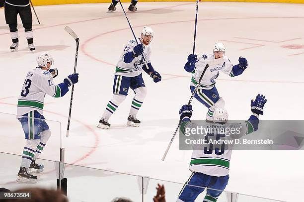 Alexander Edler, Daniel Sedin, Henrik Sedin and Shane O'Brien of the Vancouver Canucks celebrate after a goal against the Los Angeles Kings in Game...