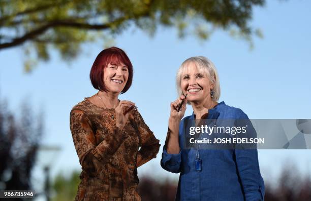 Kyle Johnson and MaryLou Molinaro, co-chairs of the Cannabis Discussion Club, pose with vape pens for a photo at Trilogy at the Vineyards in...