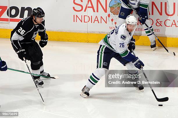 Mikael Samuelsson of the Vancouver Canucks skates with the puck against Michal Handzus of the Los Angeles Kings in Game Four of the Western...
