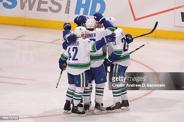 Kyle Wellwood, Steve Bernier and Alexander Edler of the Vancouver Canucks celebrate after a goal against the Los Angeles Kings in Game Four of the...