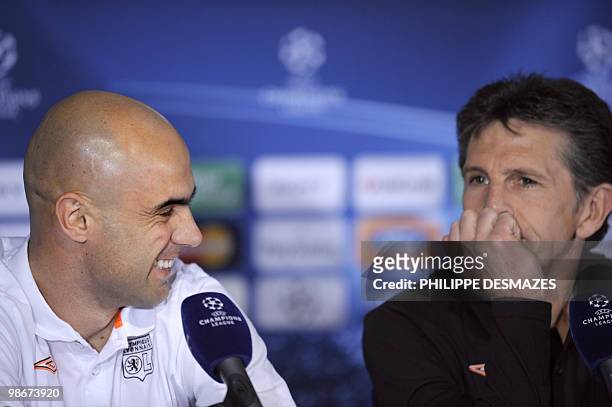 Lyon's football team's Brazilian defender Cristiano Marques smiles near coach Claude Puel smiles during a press conference on April 26, 2010 at the...