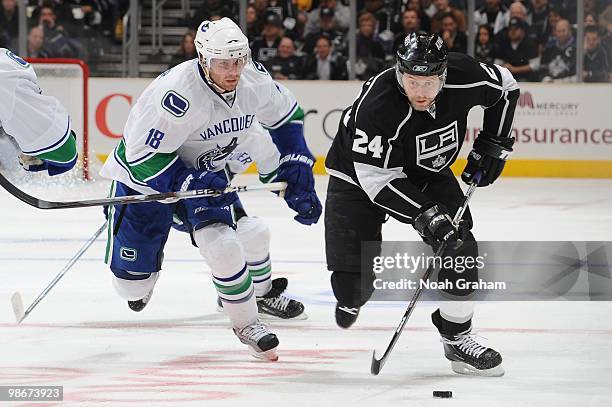 Alexander Frolov of the Los Angeles Kings skates with the puck against Steve Bernier of the Vancouver Canucks in Game Four of the Western Conference...