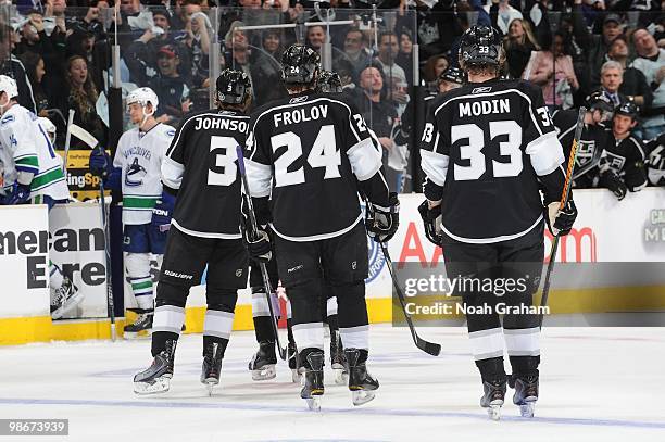 Jack Johnson, Alexander Frolov and Fredrik Modin of the Los Angeles Kings skate off the ice after a goal against the Vancouver Canucks in Game Four...